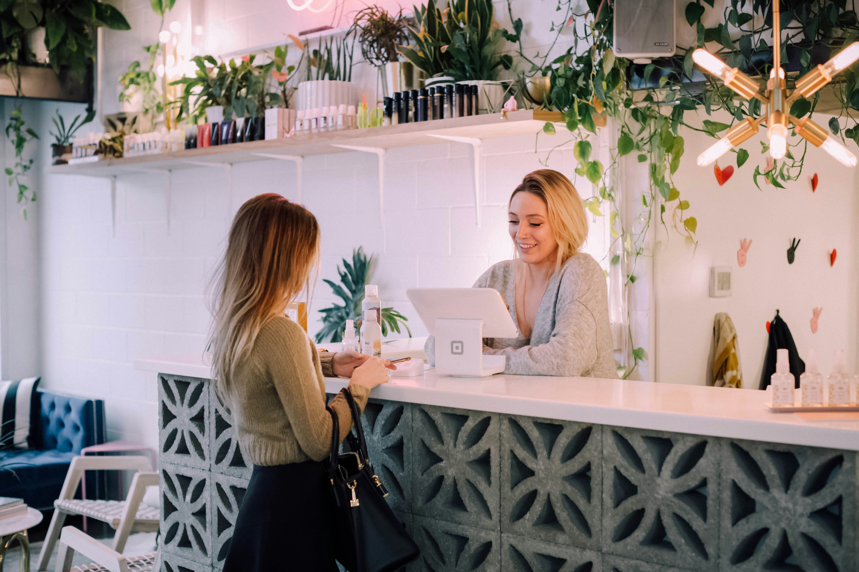 Local business storefront with customers using mobile phones to search for local services